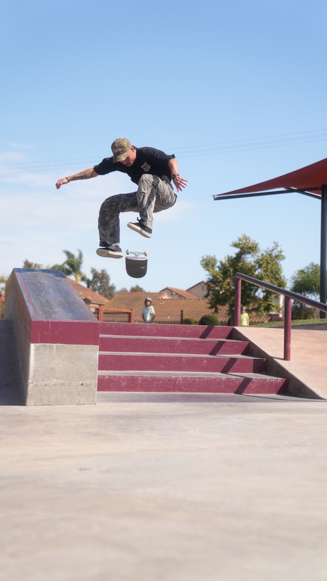 Phil Ceja ollieing at a skatepark.