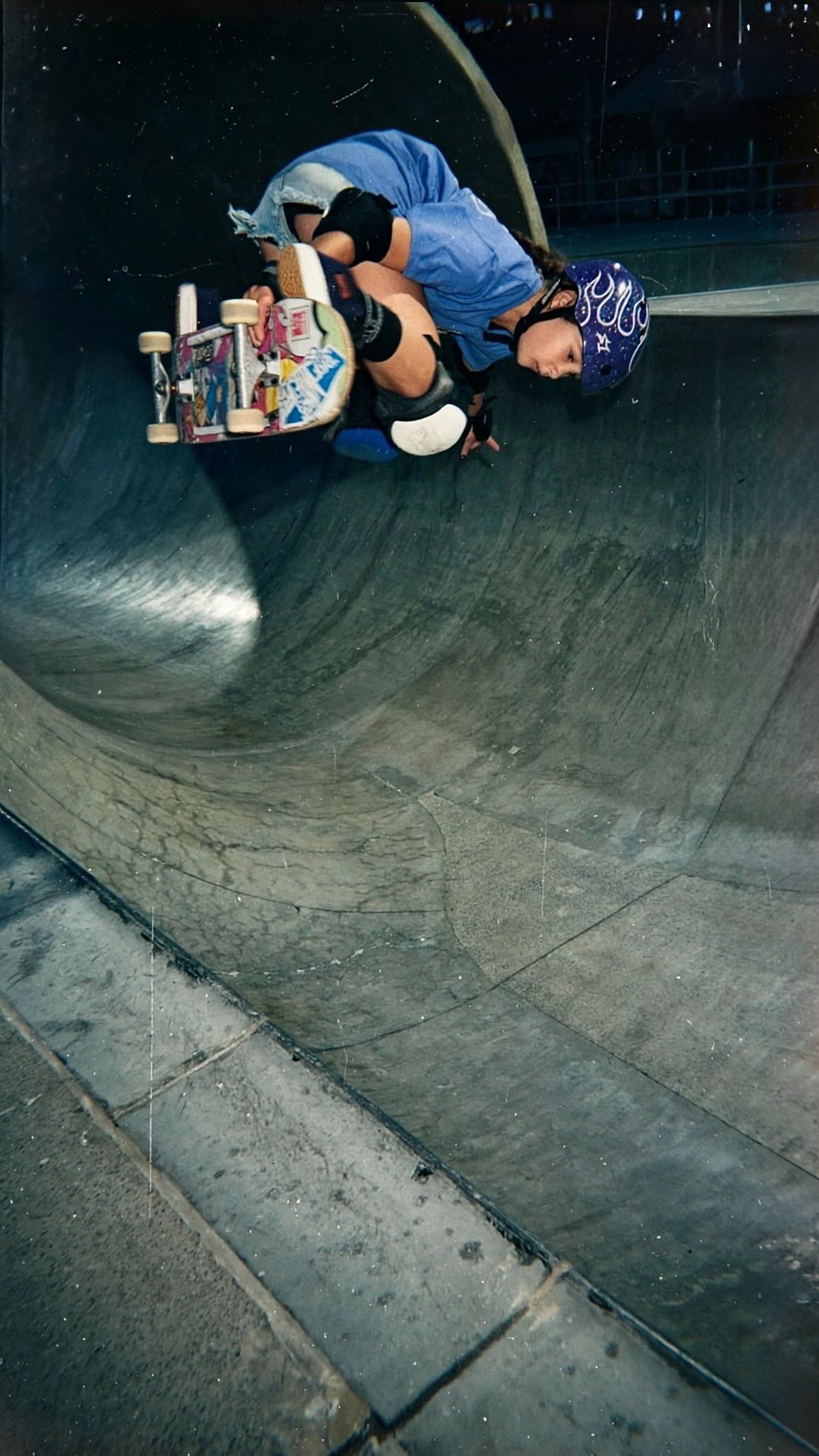 Ivy Raftery skating a bowl in a blue shirt.