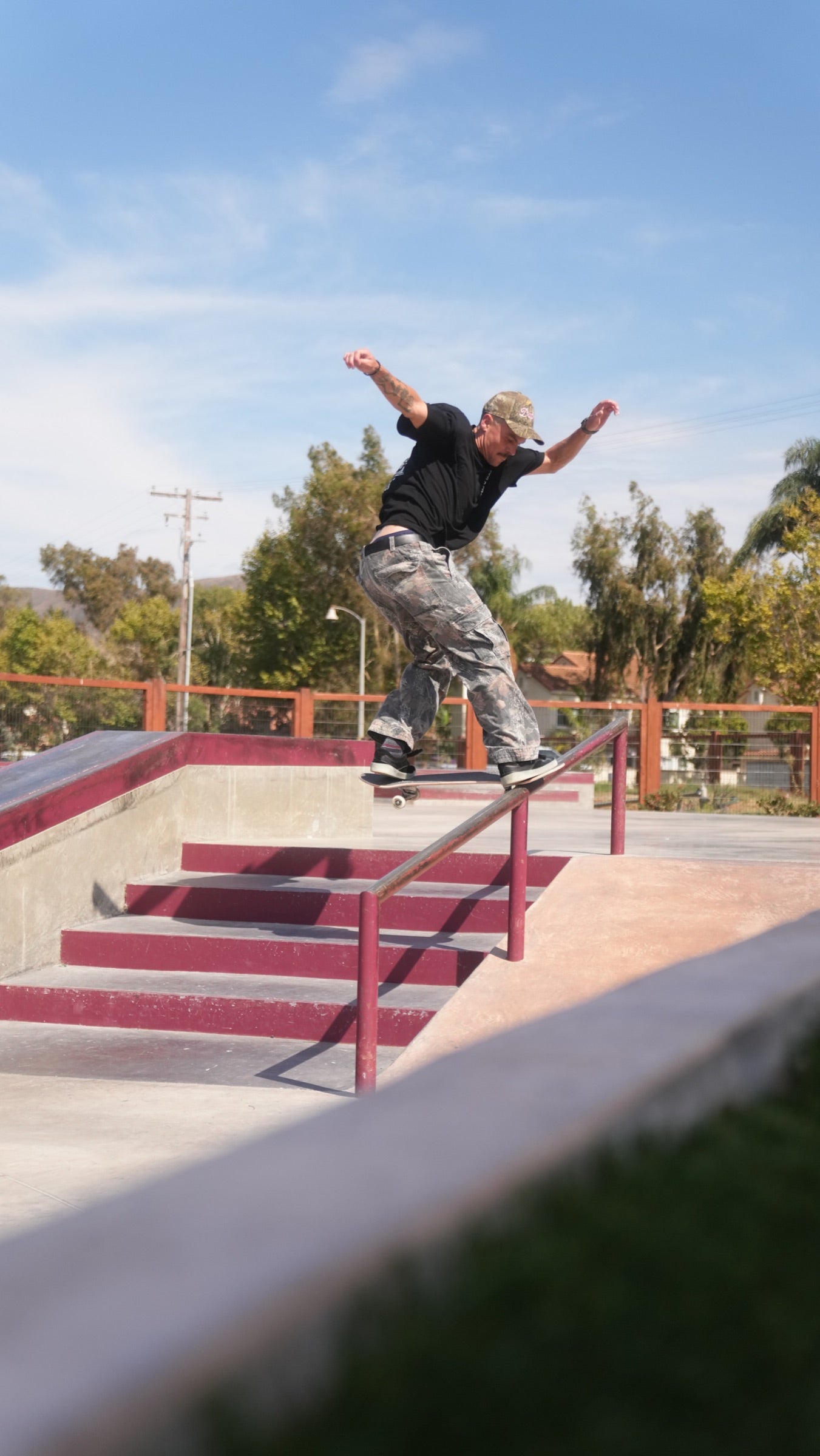 Phil Ceja skating a rail at a skatepark.