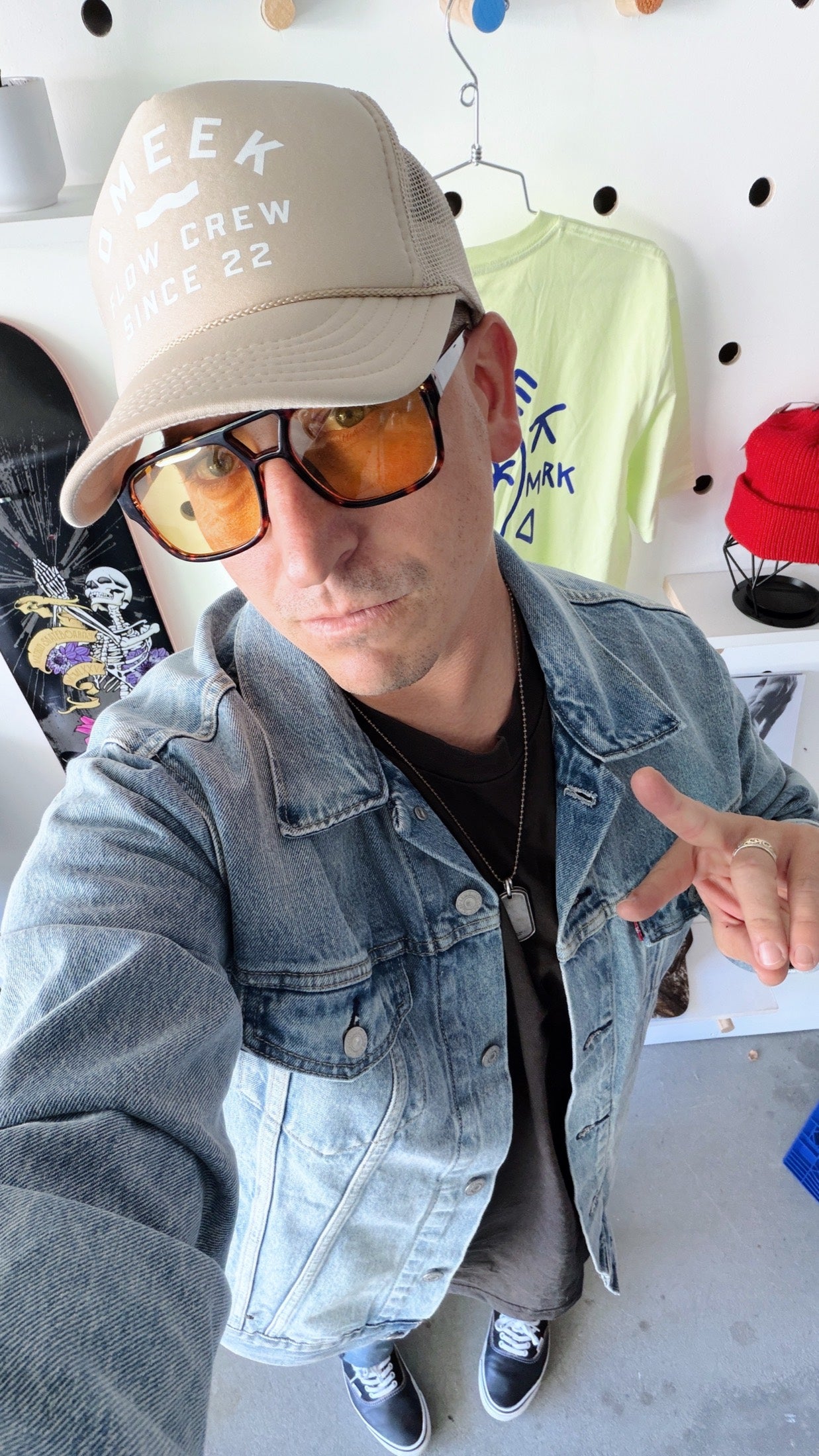 Nick D’Amico in an OMEEK cap, sunglasses, and a denim jacket.