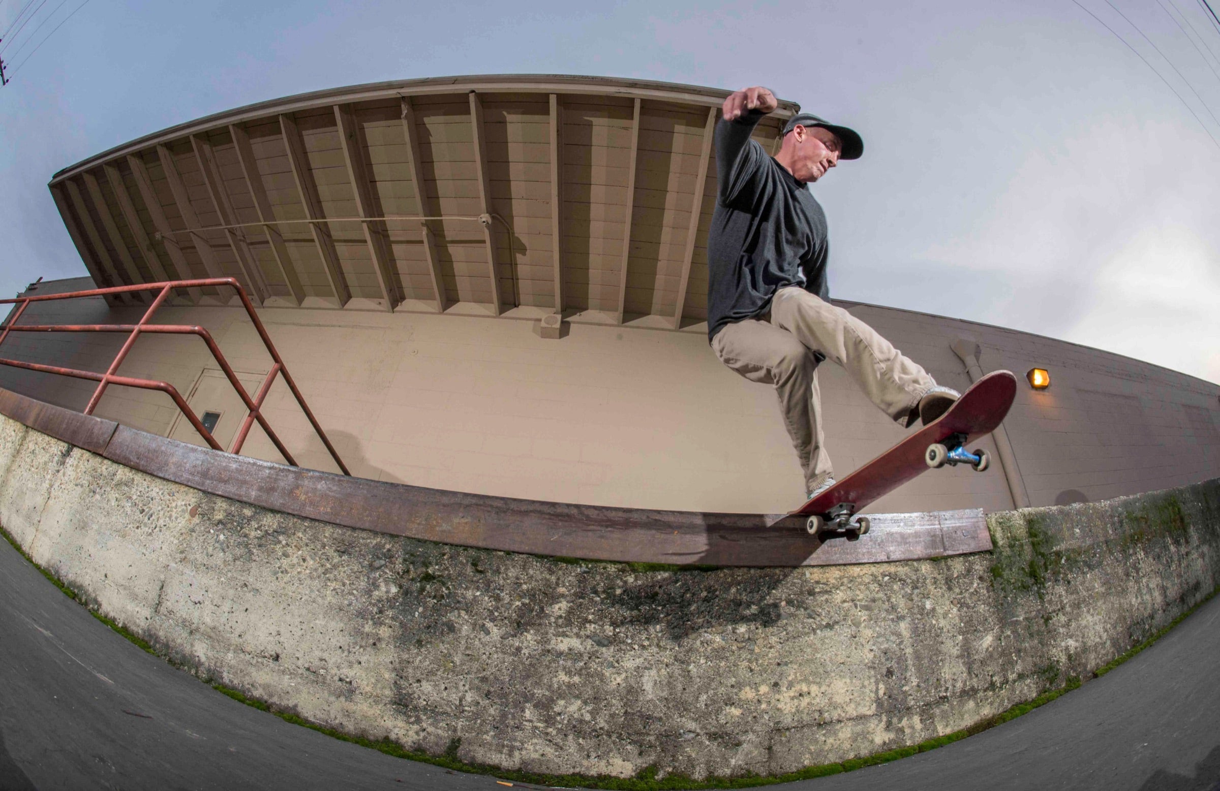 Andy Aced skating a curved concrete ramp.